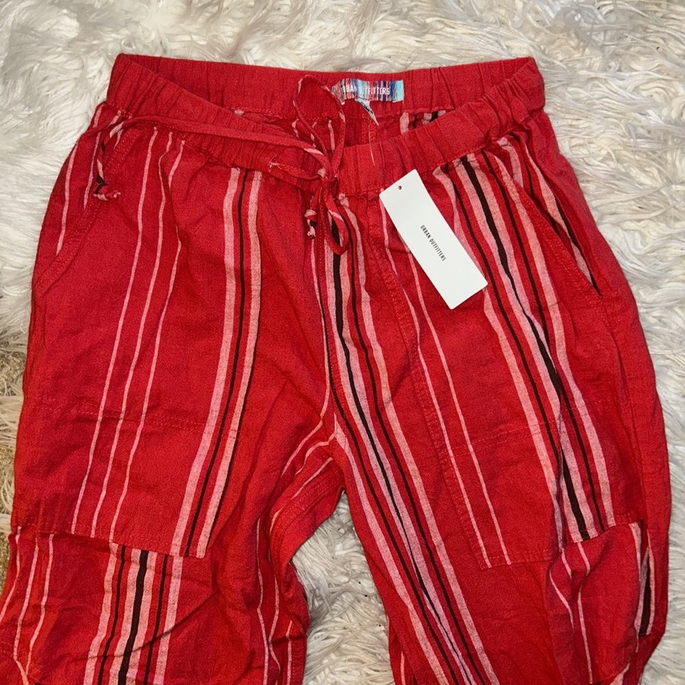 Urban Outfitters red pants with tie adjusters at the bottom